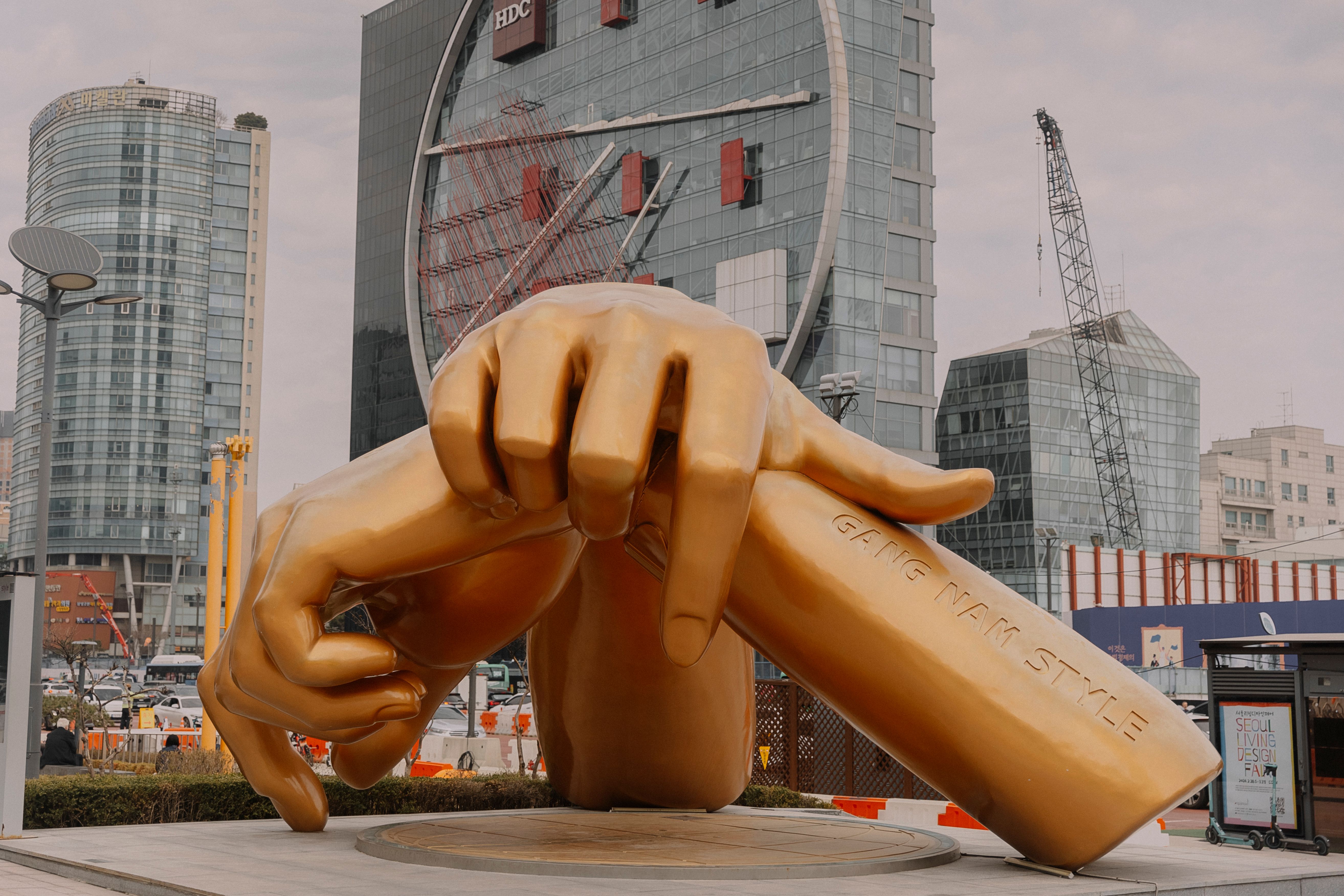 Close-up of the golden Gangnam Style bronze hands sculpture engraved with GANG NAM STYLE at COEX